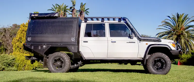 White Toyota 79 Series with an All In 4x4 flatbed and canopy