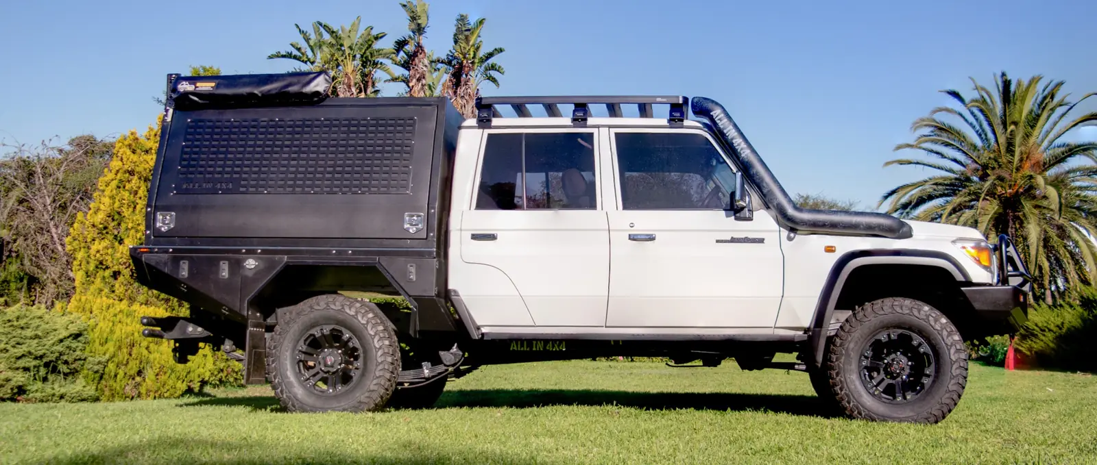 White Toyota 79 Series with an All In 4x4 flatbed and canopy