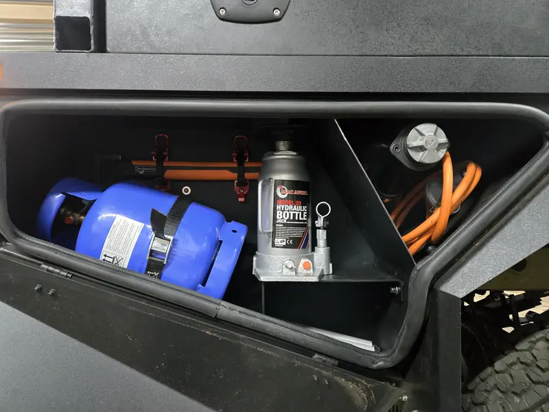 Water tank and jerry can storage inside a canopy