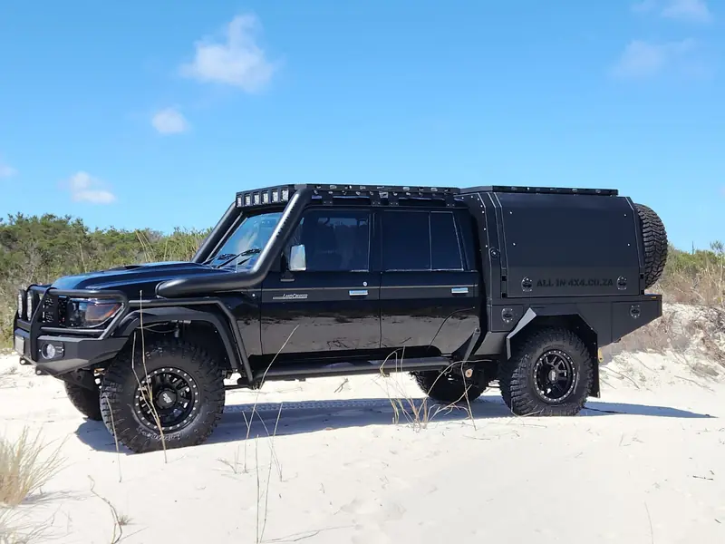 Black 79 Series flatbed and canopy build on white sand