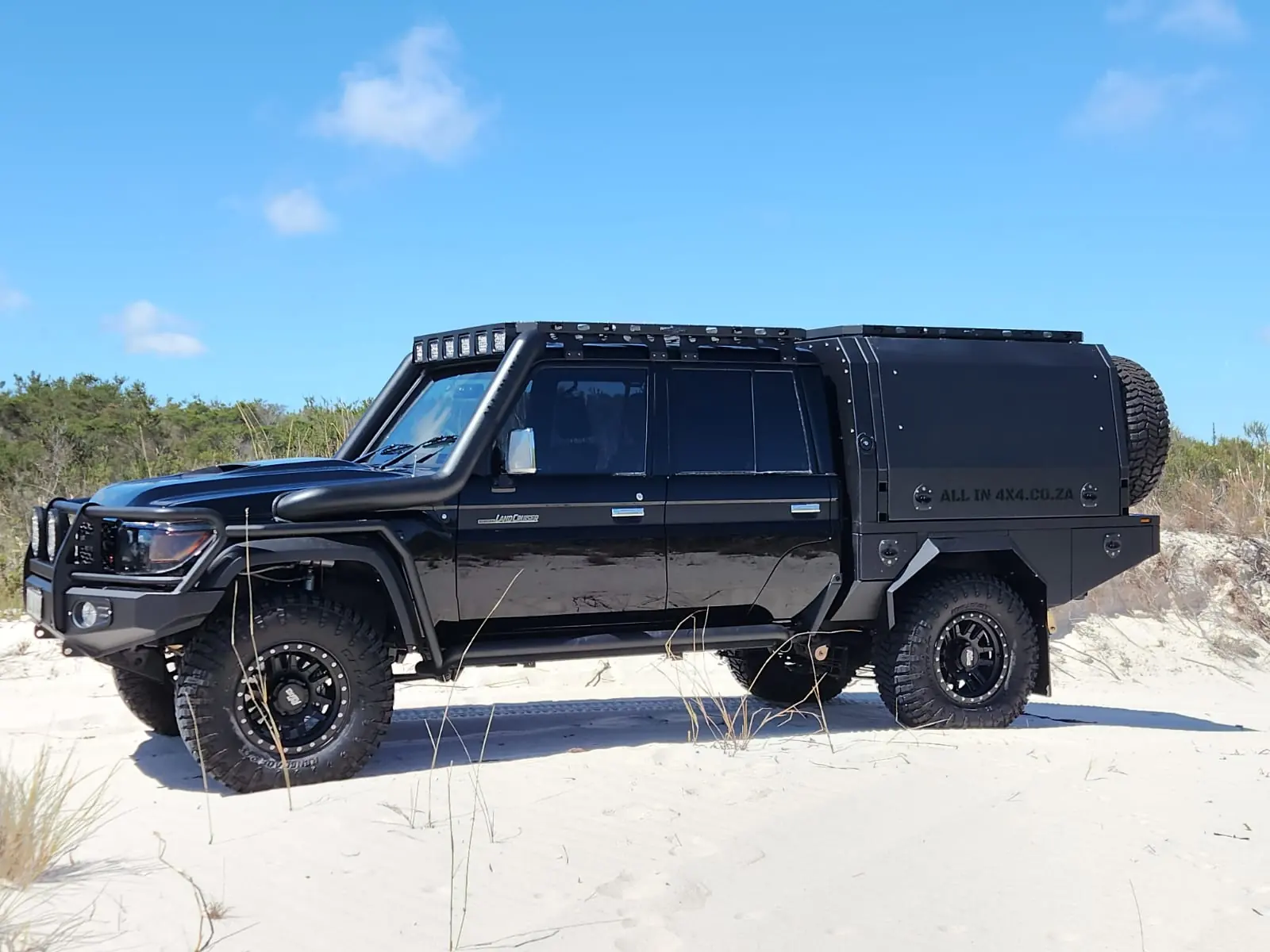 Toyota 79 Series flatbed and canopy build on white sand